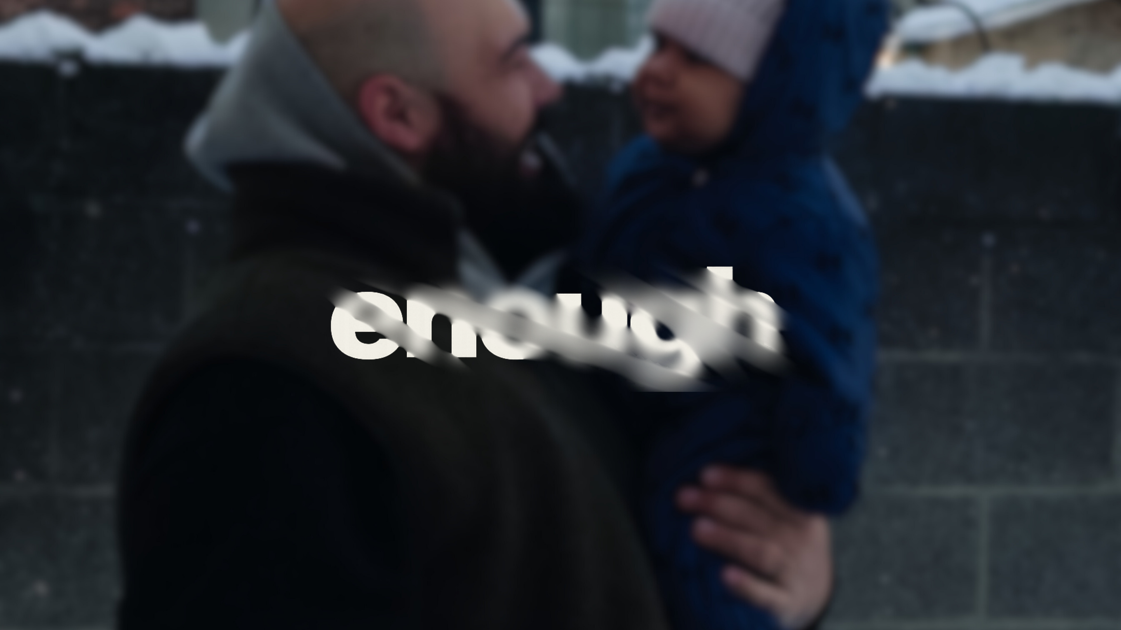 Two people embracing with the word 'enough' displayed prominently.